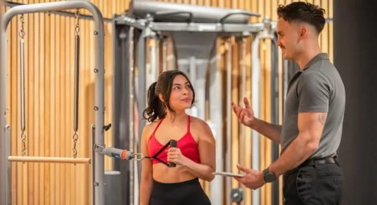 Physiotherapist performing VALD performance strength testing with client in Melbourne CBD clinic