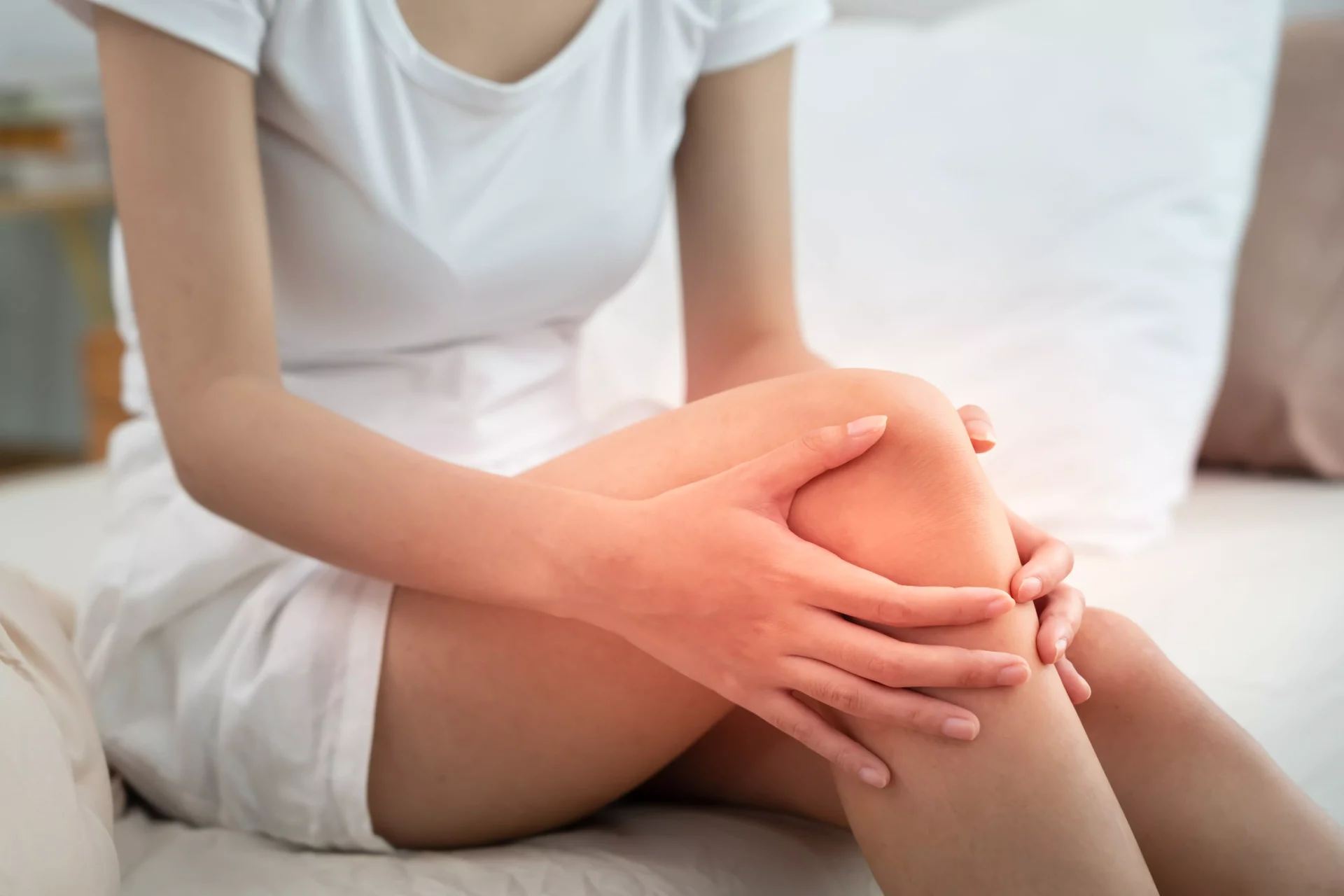 Person holding knee in pain from ACL injury showing instability and discomfort in the joint